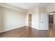 Spacious bedroom featuring wood flooring, an ensuite bathroom, and neutral color palette at 975 N Lincoln St # 10A, Denver, CO 80203