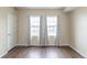 Bright bedroom featuring wood floors, large windows, and stylish gray curtains at 975 N Lincoln St # 10A, Denver, CO 80203