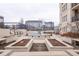 A decorative fountain sits on a patio surrounded by trimmed landscaping and exterior seating at 975 N Lincoln St # 10A, Denver, CO 80203