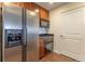 Kitchen view featuring stainless steel refrigerator, dark countertop, wood cabinets and hardwood floors at 975 N Lincoln St # 10A, Denver, CO 80203