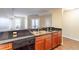 Kitchen sink and countertop with view of living spaces, dark countertop, wood cabinets and hardwood floors at 975 N Lincoln St # 10A, Denver, CO 80203