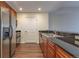 Kitchen featuring stainless steel appliances, dark countertops, wood cabinets and hardwood floors at 975 N Lincoln St # 10A, Denver, CO 80203