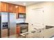 Kitchen featuring stainless steel refrigerator, dark countertop, wood cabinets and hardwood floors at 975 N Lincoln St # 10A, Denver, CO 80203