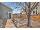 Backyard area featuring a fenced enclosure and a walkway leading to a building entrance at 16333 Prairie Farm Cir, Parker, CO 80134