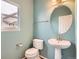Powder room with blue walls, pedestal sink and toilet at 16333 Prairie Farm Cir, Parker, CO 80134