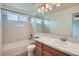 Full bathroom with shower/tub combo and a sink with cabinets at 16333 Prairie Farm Cir, Parker, CO 80134