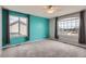 Bedroom with two windows and accent walls painted gray and teal at 16333 Prairie Farm Cir, Parker, CO 80134
