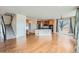 Open-concept kitchen and living area featuring wood floors, and a kitchen island for entertaining at 16333 Prairie Farm Cir, Parker, CO 80134