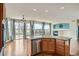 Open concept gourmet kitchen with hard wood floors, stainless appliances, and fireplace at 16333 Prairie Farm Cir, Parker, CO 80134