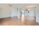 Open-concept living room with hardwood floors, arched doorways, and staircase access at 16333 Prairie Farm Cir, Parker, CO 80134