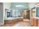Luxurious main bathroom boasts a soaking tub, glass shower, and elegant tile work at 16333 Prairie Farm Cir, Parker, CO 80134