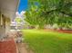 Large backyard featuring a deck, lawn, landscaping, and mature trees at 4670 E Euclid Cir, Centennial, CO 80121