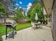 Landscaped backyard featuring a deck with dining set and grill perfect for outdoor entertaining at 4670 E Euclid Cir, Centennial, CO 80121