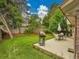 A spacious backyard with deck, dining set, and well-maintained lawn for outdoor enjoyment at 4670 E Euclid Cir, Centennial, CO 80121