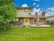 Grassy backyard featuring a brick home, and a wooden deck at 4670 E Euclid Cir, Centennial, CO 80121