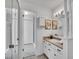 Bright and clean primary bathroom with a white vanity, framed mirrors, and a walk-in shower at 4670 E Euclid Cir, Centennial, CO 80121