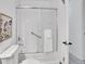 Bathroom with white tiled shower, sliding glass door, and modern fixtures at 4670 E Euclid Cir, Centennial, CO 80121