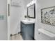 Bathroom featuring dark vanity, bright mirror, and modern fixtures at 4670 E Euclid Cir, Centennial, CO 80121
