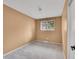 Neutral bedroom featuring plush gray carpet and a window for natural light at 4670 E Euclid Cir, Centennial, CO 80121