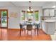 Bright dining area with wood floors, breakfast nook, backyard view, and sliding door access to backyard at 4670 E Euclid Cir, Centennial, CO 80121
