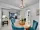 Cozy dining room featuring a round table, chandelier, and easy access to the kitchen and living area at 4670 E Euclid Cir, Centennial, CO 80121
