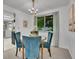 Cozy dining area featuring a round glass table, upholstered chairs, and a decorative chandelier at 4670 E Euclid Cir, Centennial, CO 80121