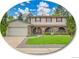 Charming two-story home featuring a manicured lawn, brick accents, and a spacious attached garage at 4670 E Euclid Cir, Centennial, CO 80121