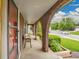 Front porch exhibiting brick archways, seating, and manicured landscaping offering an outdoor experience at 4670 E Euclid Cir, Centennial, CO 80121