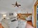 Bright living room featuring a brick fireplace, ceiling fan, and hardwood floors at 4670 E Euclid Cir, Centennial, CO 80121