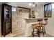 Basement bar area with a bar top counter, shelving, and seating at 4509 Eliot St, Denver, CO 80211