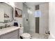 Updated bathroom featuring a glass-enclosed shower with tiled accents and modern vanity at 4509 Eliot St, Denver, CO 80211