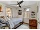 Bright bedroom with natural light, hardwood floors, ceiling fan, and calming decor at 4509 Eliot St, Denver, CO 80211