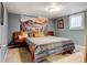 Comfortable bedroom with a decorative wall hanging over the bed and carpeted floors at 4509 Eliot St, Denver, CO 80211