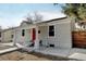 Charming home showcasing a red front door, covered porch with white columns, and a freshly updated exterior at 4509 Eliot St, Denver, CO 80211