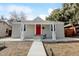 Charming home featuring a bright red front door, covered porch with white columns, and a well-manicured yard at 4509 Eliot St, Denver, CO 80211