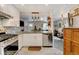 Well-lit kitchen showcasing white cabinets, granite countertops, stainless steel appliances, and open floor plan at 4509 Eliot St, Denver, CO 80211