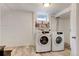 Clean laundry room features a washer, dryer, and shelving at 4509 Eliot St, Denver, CO 80211