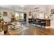 Open-concept living room and kitchen features a breakfast bar with pendant lights and hardwood flooring at 4509 Eliot St, Denver, CO 80211