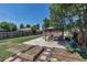 Landscaped backyard featuring a covered patio, garden beds, and lush green lawn at 3550 Magnolia St, Denver, CO 80207
