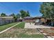 Lush backyard features patio area, garden beds and a large grassy lawn at 3550 Magnolia St, Denver, CO 80207