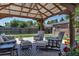 Inviting backyard patio with comfortable seating, a fire pit, and beautiful landscaping at 3550 Magnolia St, Denver, CO 80207