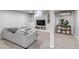 Cozy finished basement with neutral carpet, light gray walls, and built-in storage for versatile use at 3550 Magnolia St, Denver, CO 80207