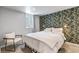 Charming bedroom with a large window, stylish wallpaper, and a comfortable seating area at 3550 Magnolia St, Denver, CO 80207