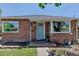 Charming brick home featuring a light blue front door and updated fixtures at 3550 Magnolia St, Denver, CO 80207