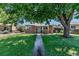 Charming brick home with a well-maintained front yard and mature shade tree at 3550 Magnolia St, Denver, CO 80207