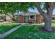 Charming brick home with a well-manicured lawn and inviting curb appeal at 3550 Magnolia St, Denver, CO 80207