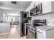 Modern kitchen with stainless steel appliances and sleek countertops, open to the living area at 3550 Magnolia St, Denver, CO 80207