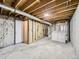 Unfinished basement with visible utilities including a washer and dryer hookups at 11167 W 17Th Ave # 104, Lakewood, CO 80215