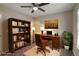 Staged office features a bookshelf, desk, and a ceiling fan at 7877 York St # 1, Denver, CO 80229