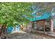 Charming backyard featuring mature trees, a wooden deck, and a storage shed, perfect for outdoor living at 12333 Newport Ct, Brighton, CO 80602